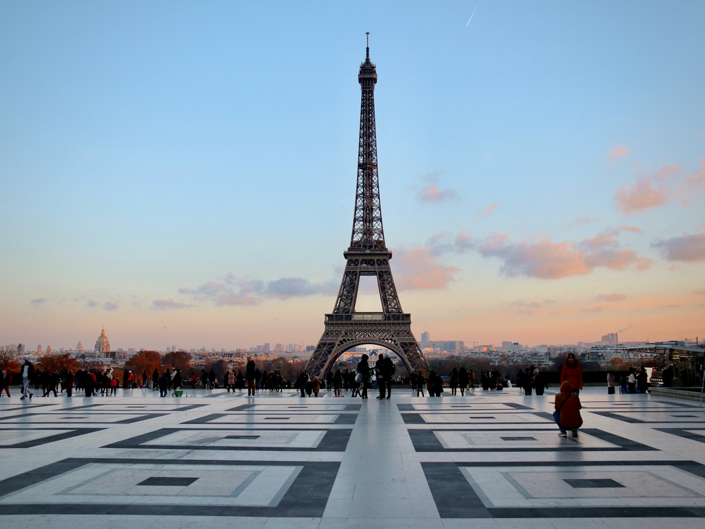 The Eiffel Tower seen across the Trocadéro esplanade at sunset